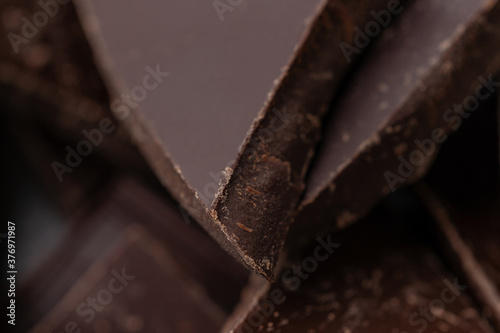 Dark chocolate cracked pieces closeup macro