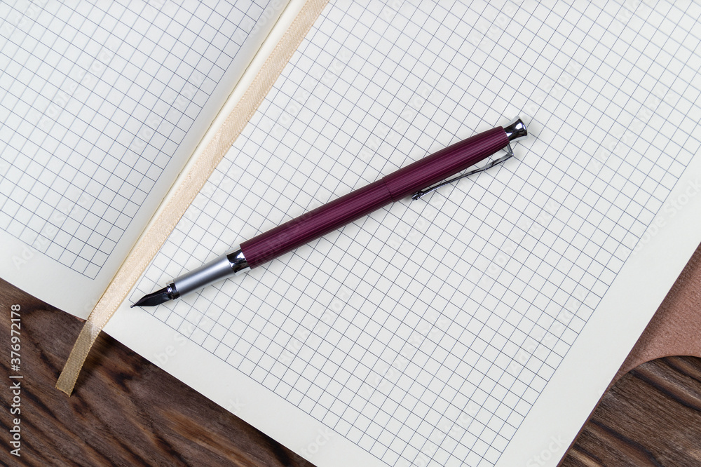 Open daily planner on wooden background. Copyspace template and branding mockup.