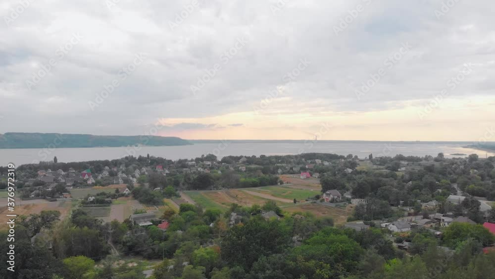 Village forest and river aerial drone left side camera movement