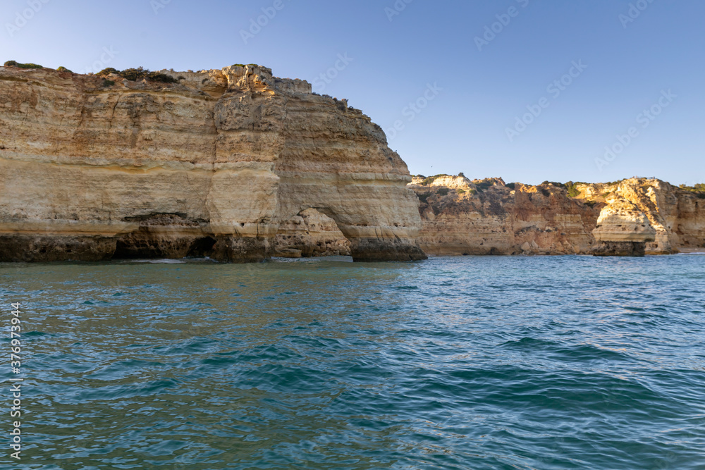 Fototapeta premium View of the beautiful rocks and cliffs beaches in Portimao City Coast, famous tourist destination in Portugal.