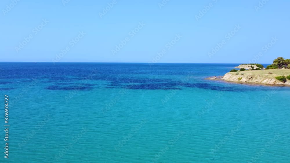 Seacoast and turquoise clear tranquil sea in summer season. Aerial view Seacoast and turquoise clear tranquil sea in summer season. Aerial view