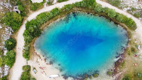 Source Of The River Cetina, Croatia, aerial view. Unique deep karst lake with clear blue water near Omis, Croatia.