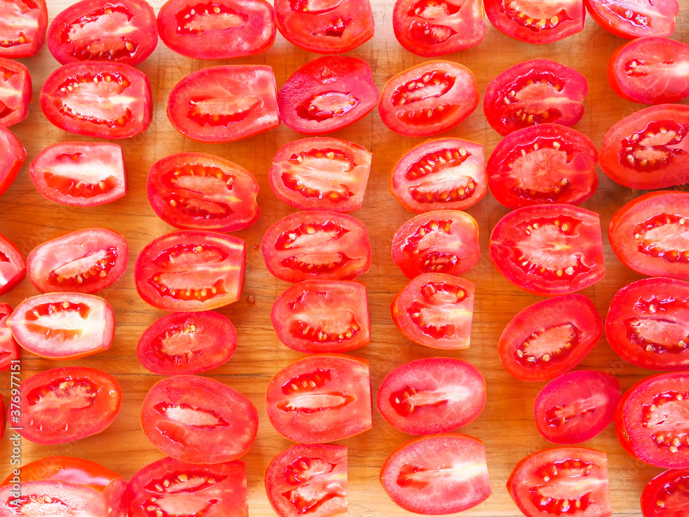 sliced tomatoes on a Board. drying sweet tomatoes. taste of summer. sliced tomatoes on a Board. drying sweet tomatoes. taste of summer.