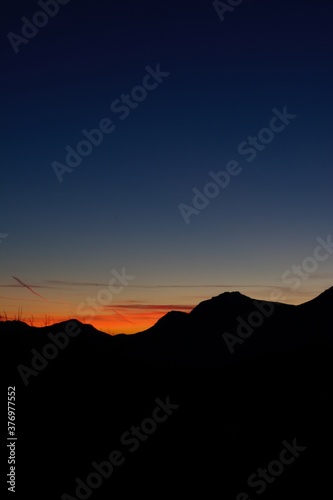 scenic sunset in Trentino Italy with mountains silhuette and colorful sky