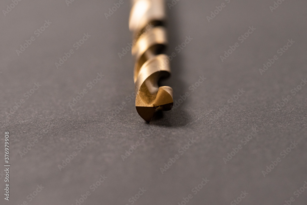 Macro abstract of titanium drill bits on workbench. Macro abstract of titanium drill bits on workbench.