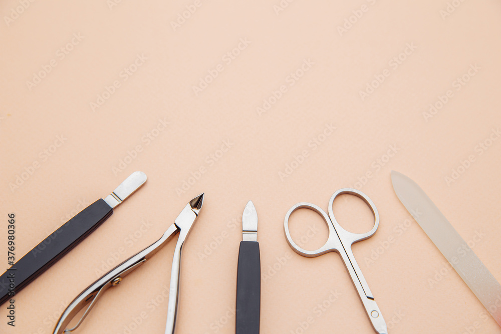 Tools of a manicure set on a pink background. Close-up. Nail and beauty care concept. Tools of a manicure set on a pink background. Close-up. Nail and beauty care concept.