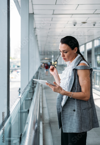 Serious business woman using tablet stock photo