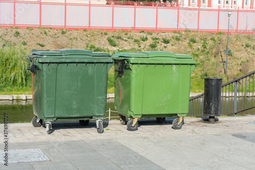 large plastic trash cans on the city waterfront