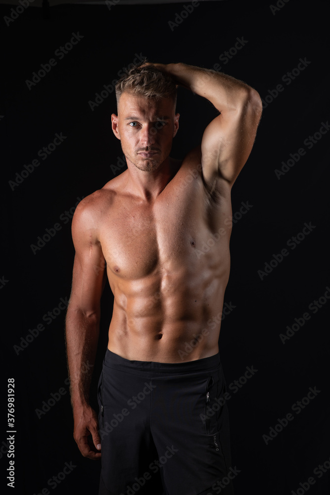 Fototapeta premium handsome muscular topless man on studio background, sport