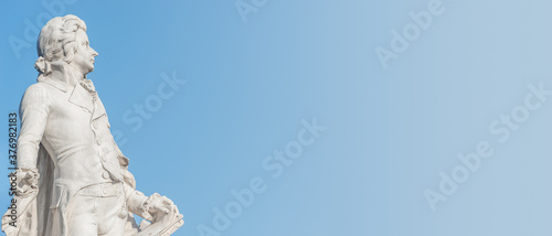 Banner with Mozart monument in historical downtown of Vienna, Austria at sunny day, blue sky with copy space for text, details photo