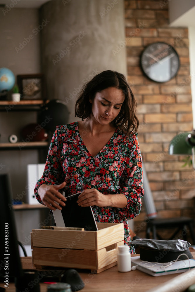 Young businesswoman in office organizing documents. Young woman working in the office. Young businesswoman in office organizing documents. Young woman working in the office.