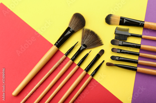 background with set of professional makeup brushes top view