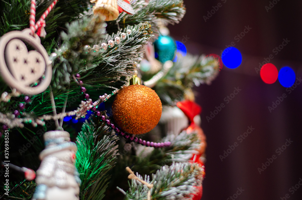 christmas tree close-up with christmas decorations, background with shallow depth of field