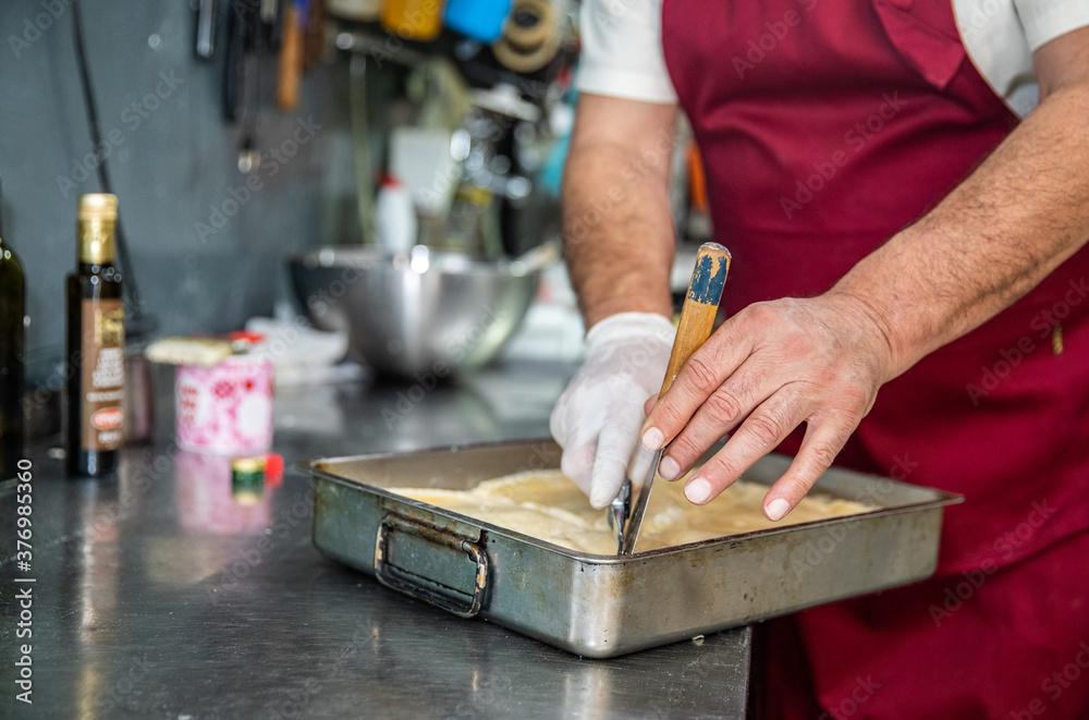 Close Up of Hands With Knife Cutting Pastry In A Pan in Belgrade Serb Close Up of Hands With Knife Cutting Pastry In A Pan in Belgrade Serb