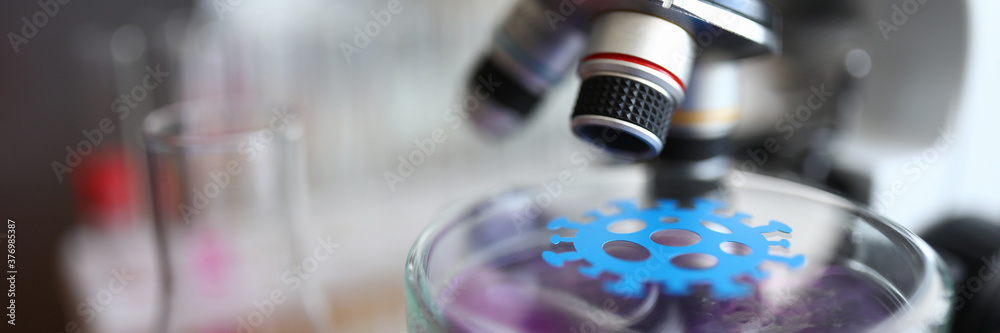 Close-up of laboratory microscope and germ under investigation. Glass tubes with colourful covers. Invisible microbes everywhere. Modern lab and medicine concept