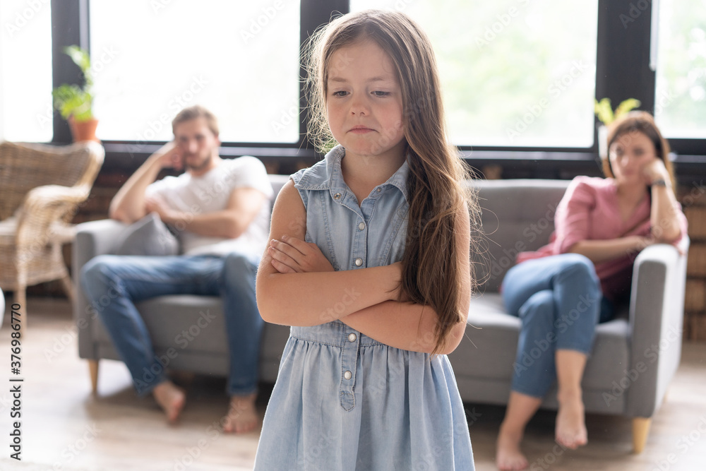Closeup of a sad girl while parents quarreling in the home Closeup of a sad girl while parents quarreling in the home