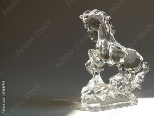 Highlighted Glass Horse in Light Beam