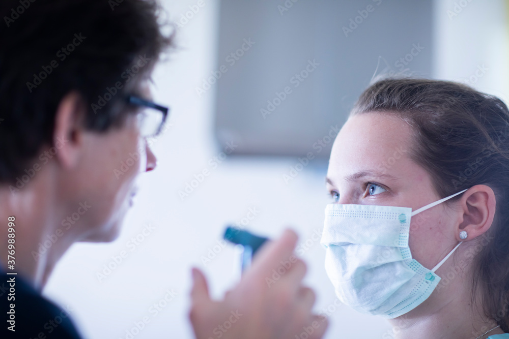 nurse and patient with mouthpiece and syringe