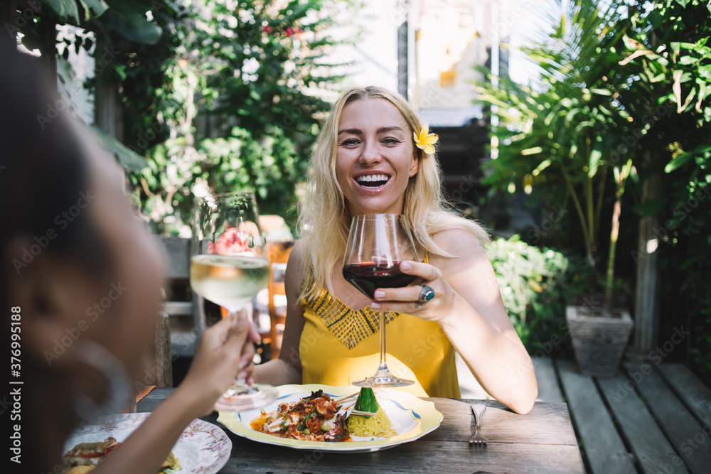 Cheerful woman with wine resting in outdoor cafe Cheerful woman with wine resting in outdoor cafe