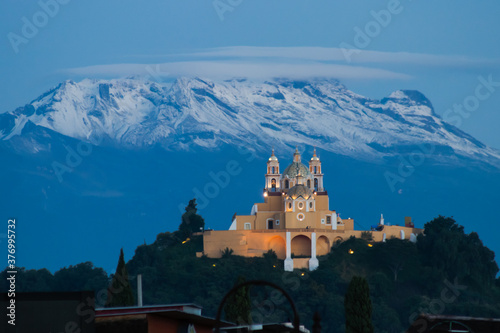 Remedios church and pyramid of cholula with iztaccihuatl volcano in the background at sunrise photo