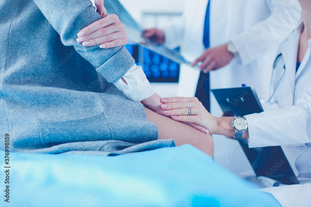 Doctor and patient discussing scan results in diagnostic center Doctor and patient discussing scan results in diagnostic center