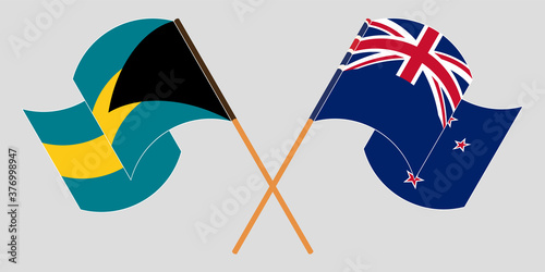 Crossed and waving flags of Bahamas and New Zealand