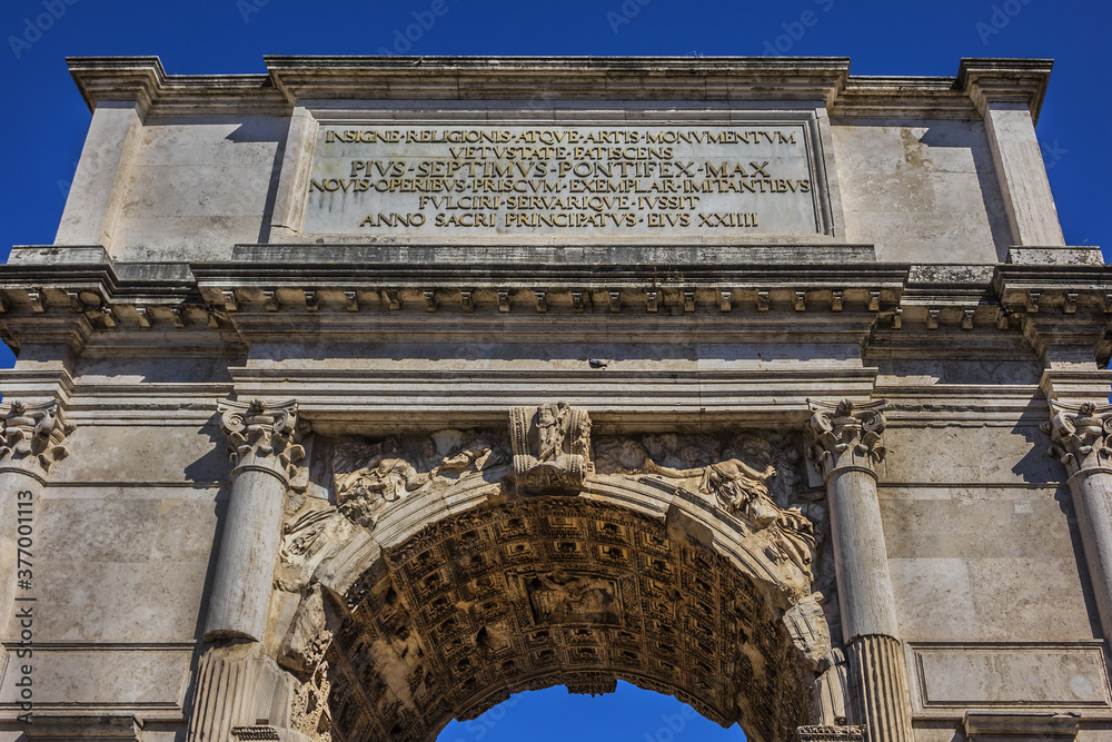 Right next to Colosseum stands Arch of Constantine, erected in early fourth century to celebrate victory of Constantine over Emperor Maxentius. Arch decorated with statues and reliefs. Rome. Italy.