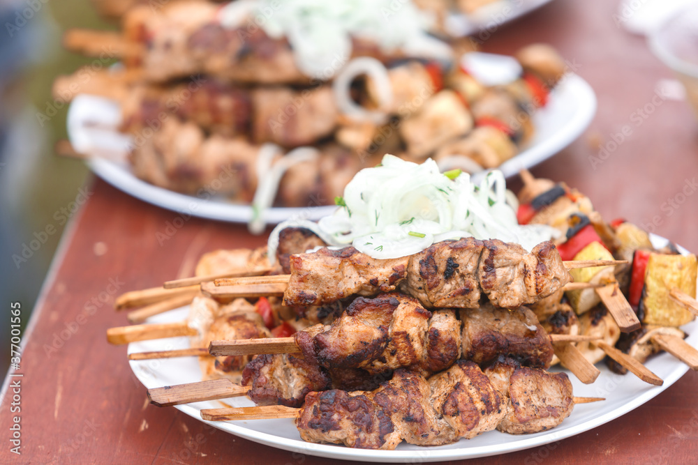Shish kebab on wooden skewers is on a plate