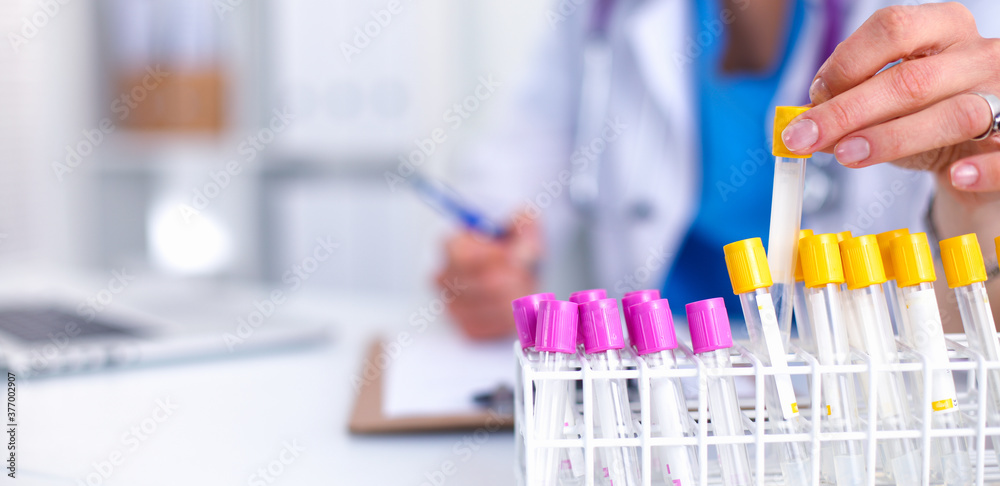 Woman researcher is surrounded by medical vials and flasks, isolated on white background Woman researcher is surrounded by medical vials and flasks, isolated on white background