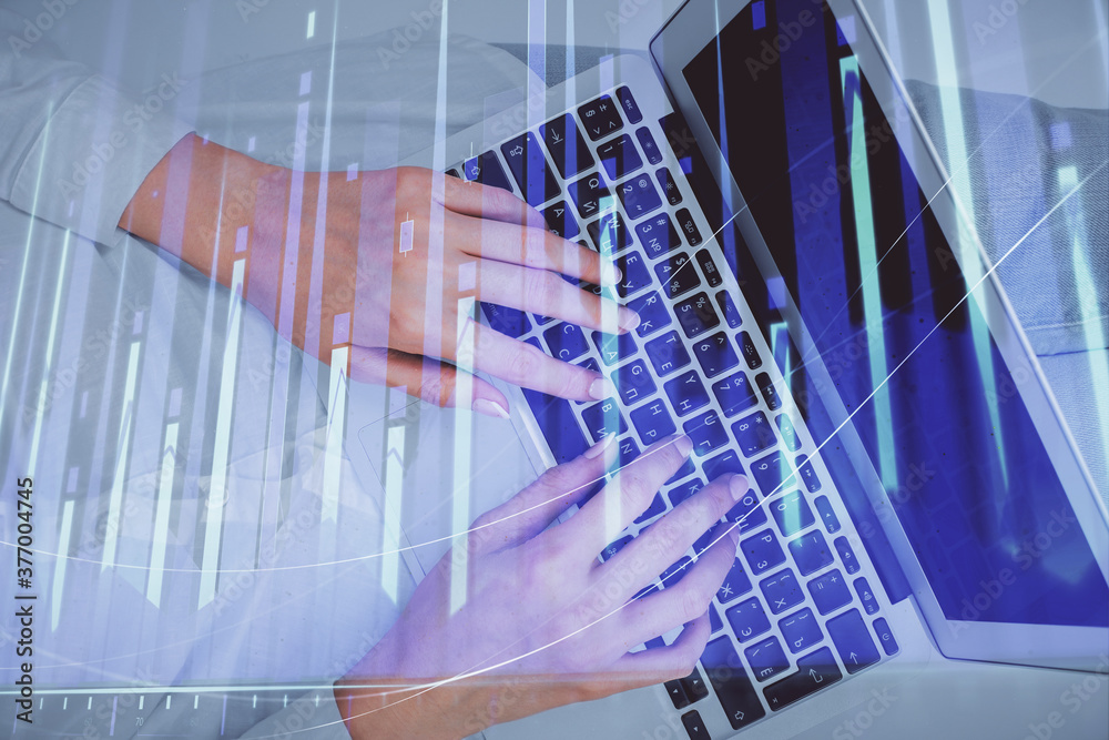 Double exposure of woman hands working on computer and forex chart hologram drawing. Top View. Financial analysis concept. Double exposure of woman hands working on computer and forex chart hologram drawing. Top View. Financial analysis concept.
