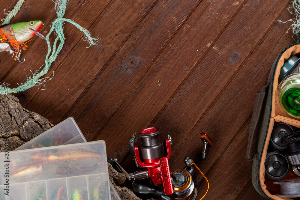 Fishing tacles on wooden background. Fishing tacles on wooden background.