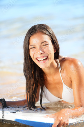 Photography Water sport fun - beach woman bodyboarding surfing on bodyboard or boogieboard