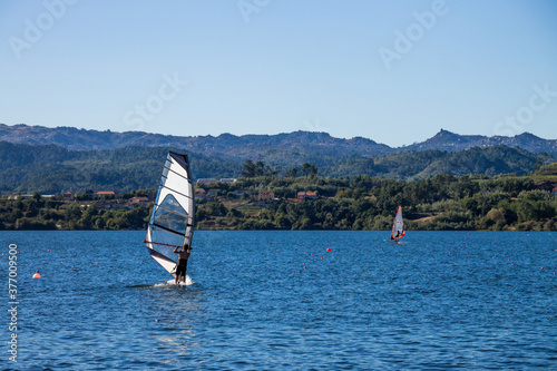 Man training windsurf on a lake in a sunny day