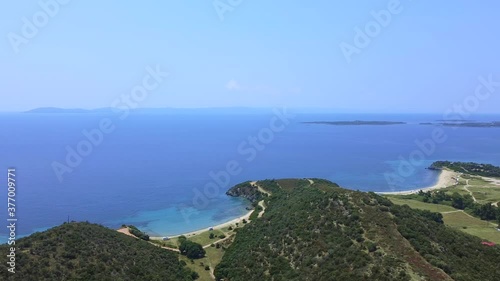 Wallpaper Mural Hilly coast covered by pine trees and open blue sea in summer season. Aerial view  Torontodigital.ca
