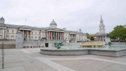 Lockdown in London, Slow motion Gilmbal walk of Empty Trafalgar Square fountain & The National Gallery during coronavirus pandemic 2020, empty streets with flying birds.
