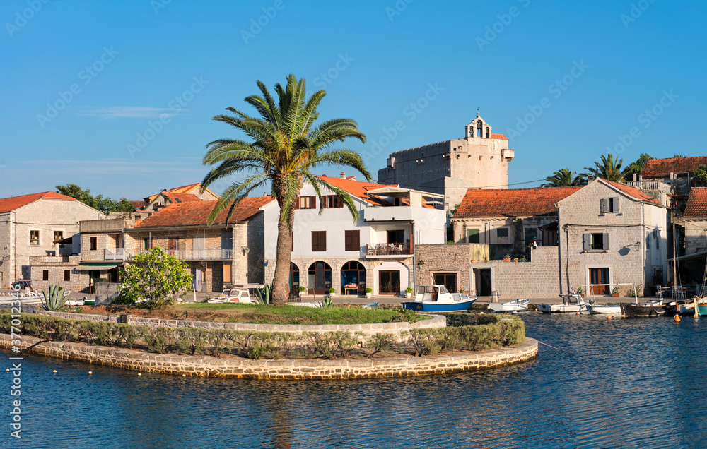 Boats and houses in Vrboska village, Hvar island, Dalmatia, Croatia, Europe. Travel and vacation destination. Old fisherman village popular with yacht men and tourists