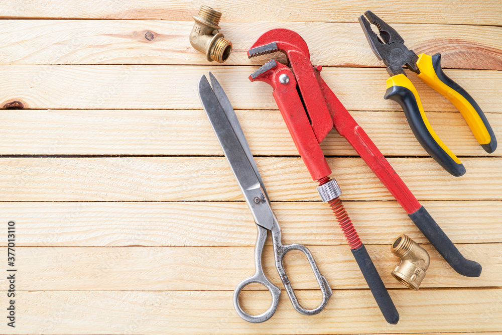 domestic plumber accessories set on a wooden desk. tools for housework domestic plumber accessories set on a wooden desk. tools for housework