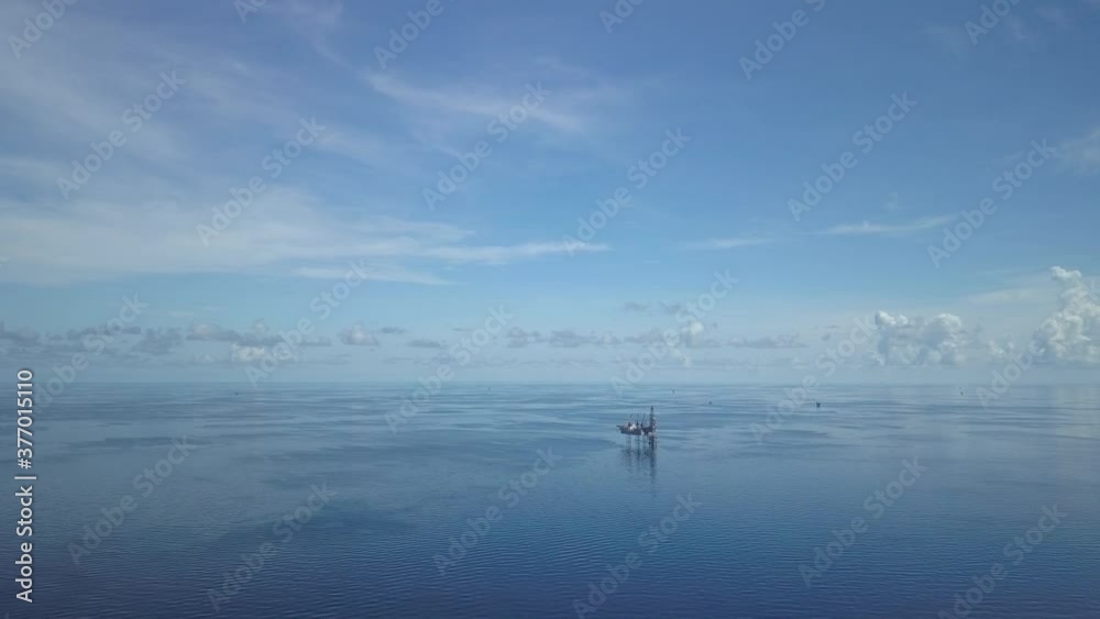 Aerial view from a drone of an offshore jack up rig and offshore supply vessels at the offshore location during day time
Aerial view from a drone of an offshore jack up rig and offshore supply vessels at the offshore location during day time