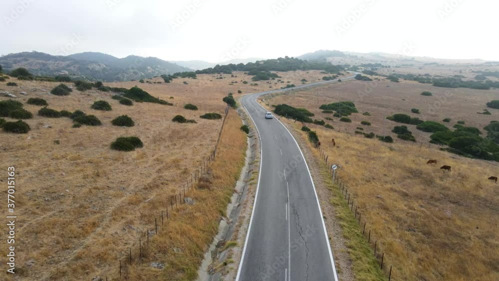 Road trip in Andalucia, Spain - drone shot of a car driving on a scenic road. Road trip in Andalucia, Spain - drone shot of a car driving on a scenic road.