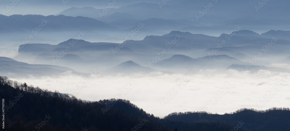 Naklejka premium Mountains in the fog.