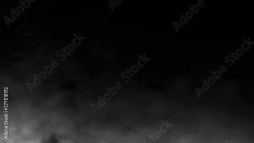 Atmospheric smoke.White smoke slowly floating through space against black background. Fog effect.