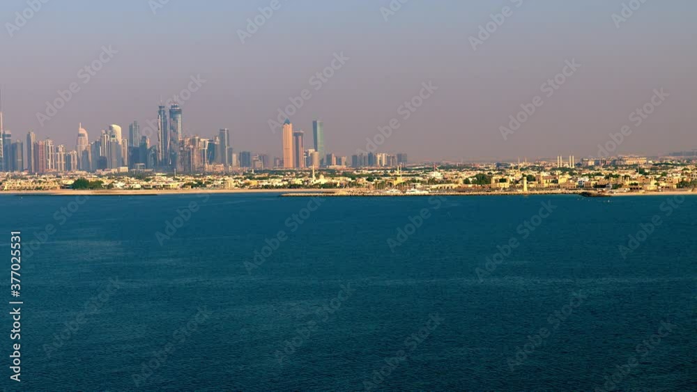 A breathtaking areal view of Dubai Skyline capturing a extrem long shot from see of persian gulf panning to the right , 6-axis stabilized gimbal, Shotover F1, 8K, parallax. A breathtaking areal view of Dubai Skyline capturing a extrem long shot from see of persian gulf panning to the right , 6-axis stabilized gimbal, Shotover F1, 8K, parallax.