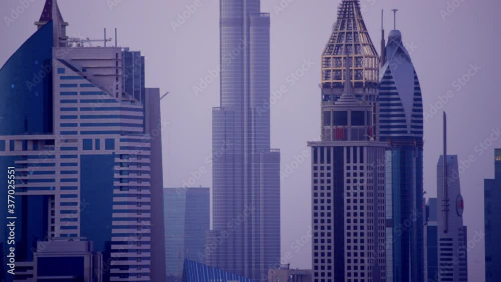 A mesmerizing aerial shot of downtown Dubai as the camera pans and zooms to the world's tallest building the Burj Khalifa and a captivating color of the horizon, 6-axis stabilized, F1, 8K, parallax. A mesmerizing aerial shot of downtown Dubai as the camera pans and zooms to the world's tallest building the Burj Khalifa and a captivating color of the horizon, 6-axis stabilized, F1, 8K, parallax.