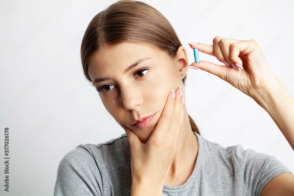 Close up of a beautiful young woman experiencing a painful toothache Close up of a beautiful young woman experiencing a painful toothache