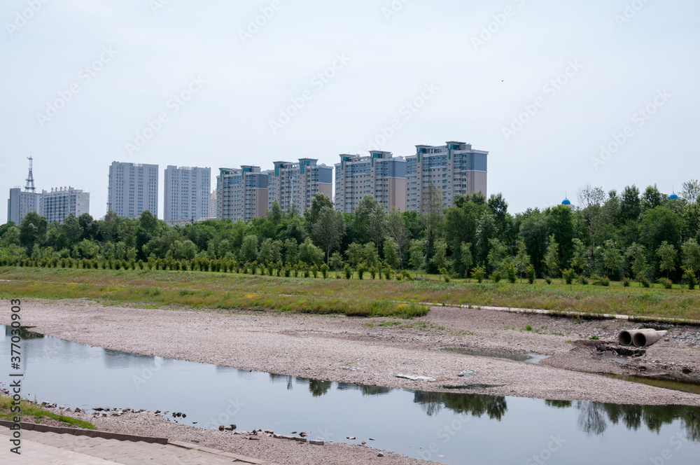 Fototapeta premium China, Heihe, July 2019: Residential high-rise buildings along the waterfront in Heihe city in summer