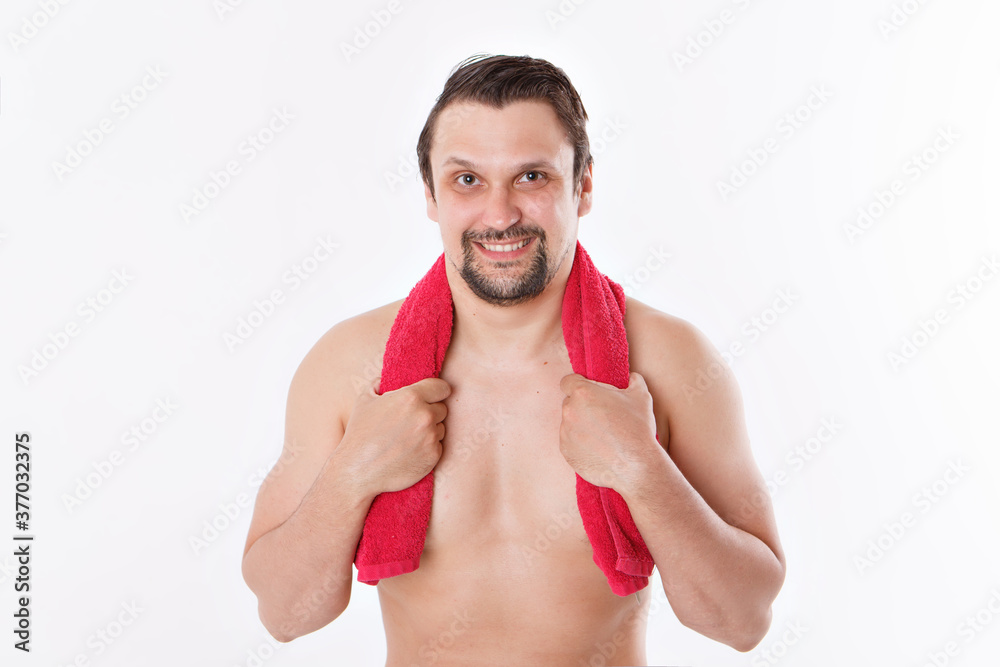 the guy strokes his beard. morning treatments in the bathroom. blue towel around her neck. isolated on a white background. copy space the guy strokes his beard. morning treatments in the bathroom. blue towel around her neck. isolated on a white background. copy space