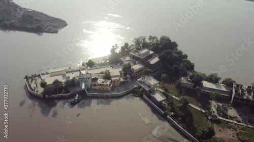 Aerial View Of Sadh Belo Island Temple On The Indus River, Pakistan. Follow Shot photo