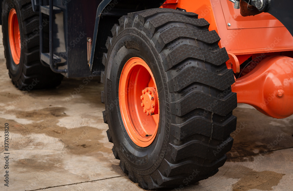 tire of red tractor on the road tire of red tractor on the road