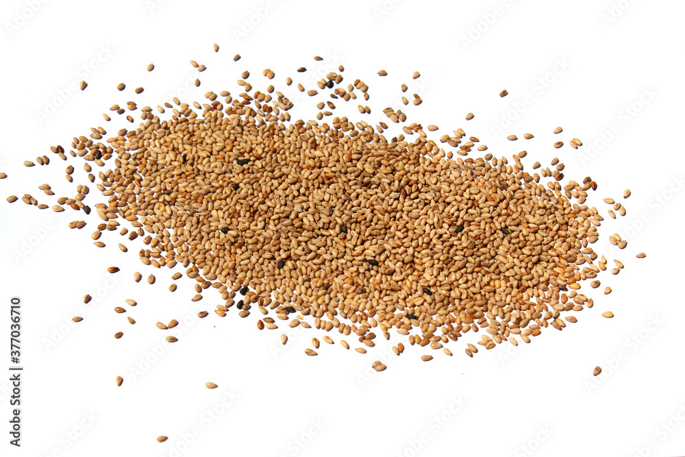 Heap of organic natural sesame seeds over isolated on white background Heap of organic natural sesame seeds over isolated on white background