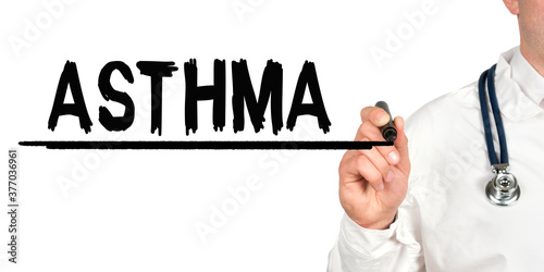 Doctor writes the word - ASTHMA. Image of a hand holding a marker isolated on a white background.